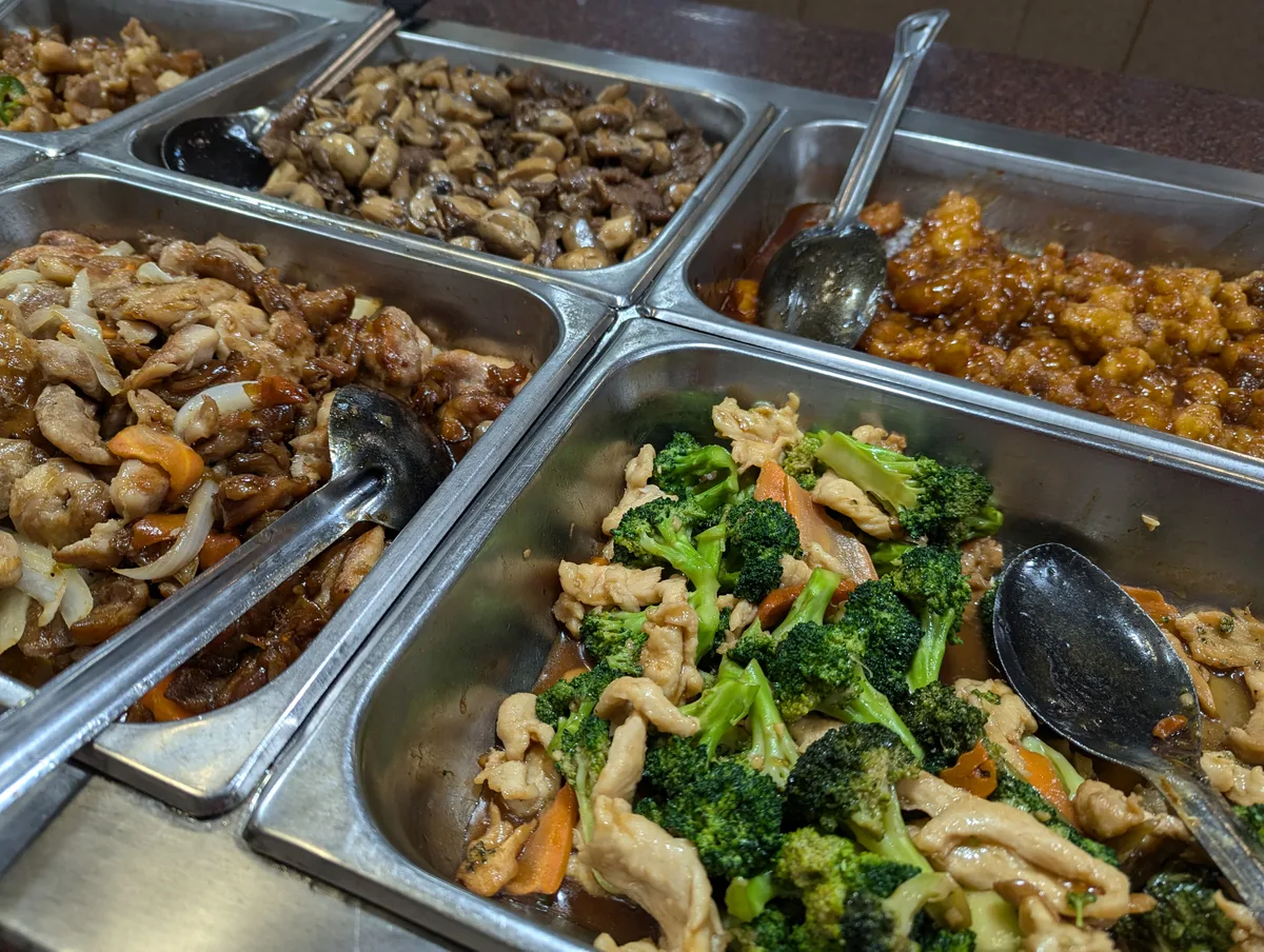 Broccoli, chicken & other dishes on the buffet